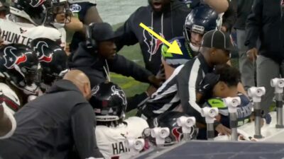 NFL referee Nate Jones protecting Seahawks wide receiver Jaxon Smith-Njigba