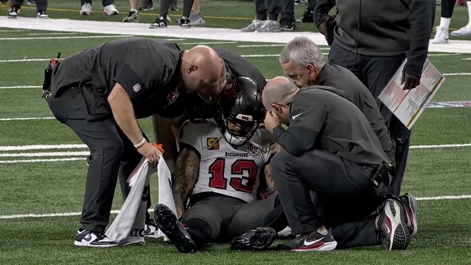 Mike Evans getting attended to by medical staff after violent crash landing