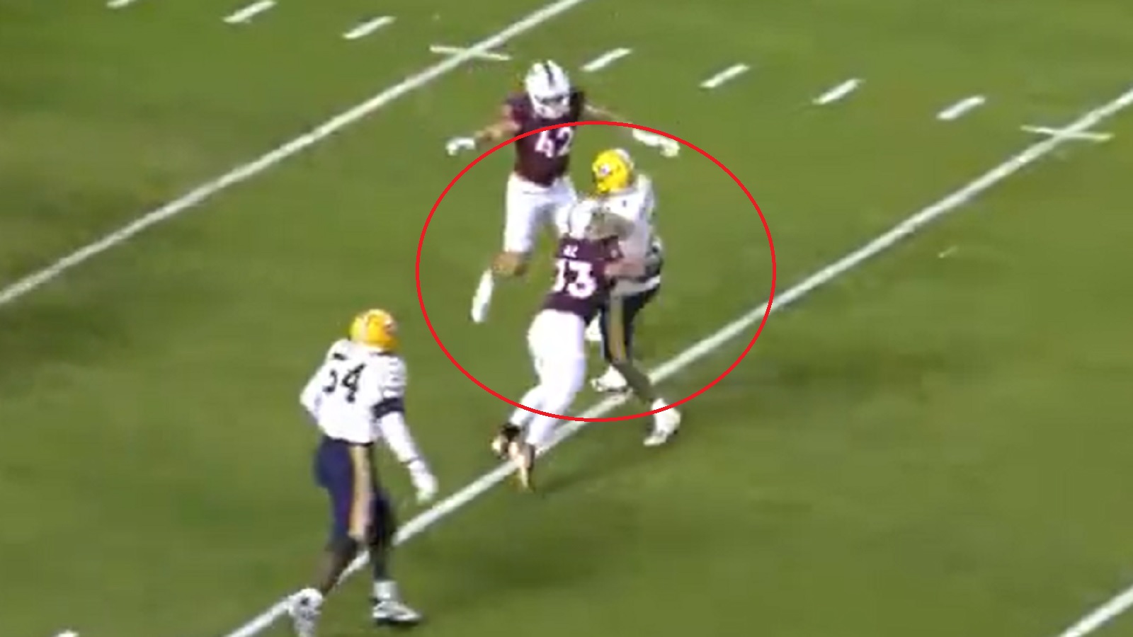 A Virginia Tech player makes a hit