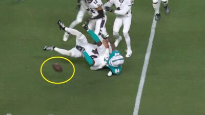 Tahj Washington fumbling the ball