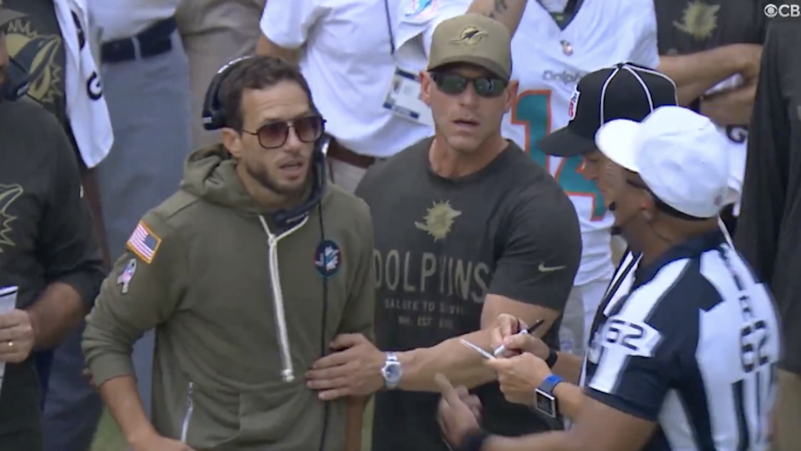 Mike McDaniel talks with a referee