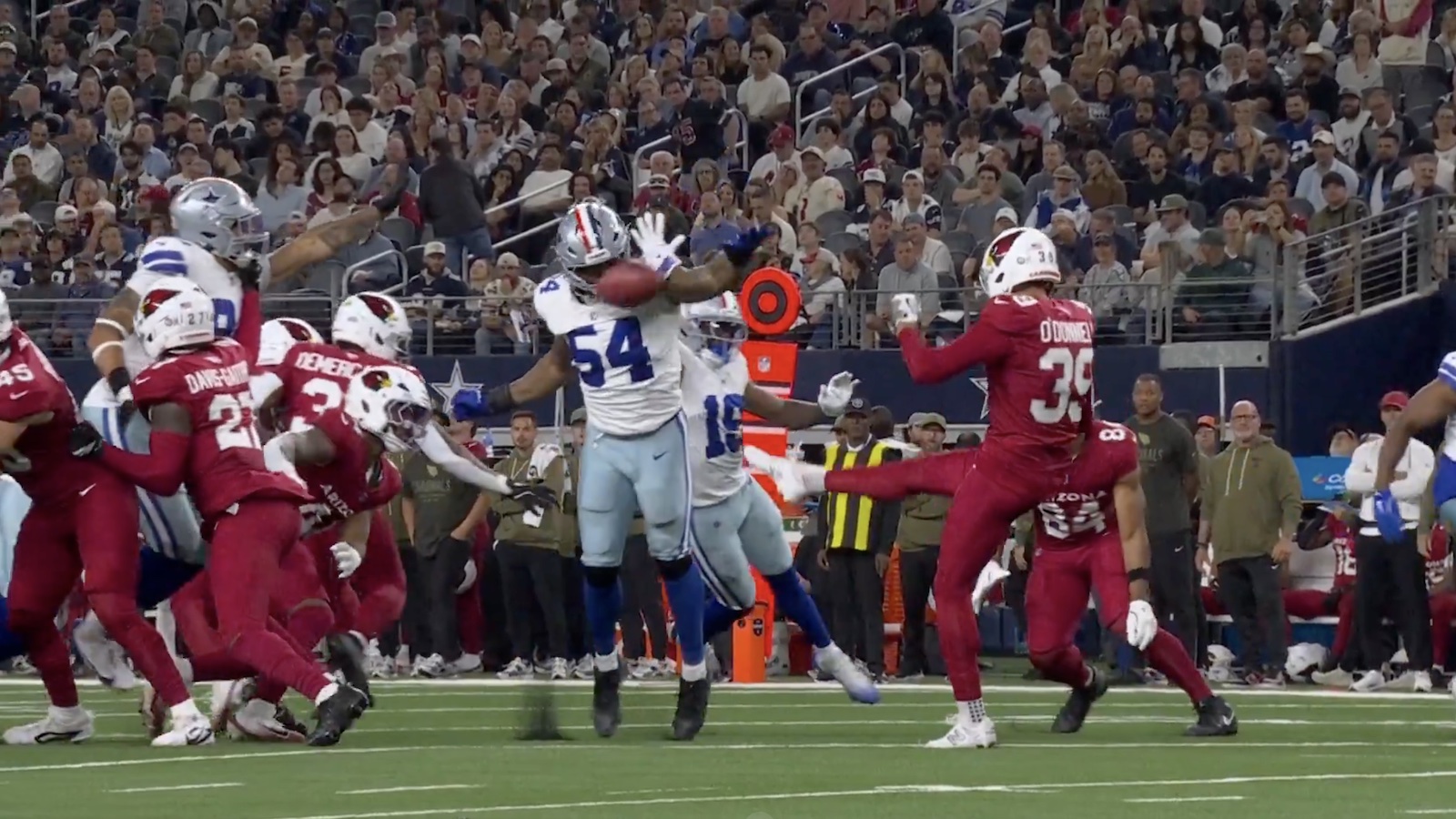 Cardinals' punt hits off the helmet of a Cowboys player
