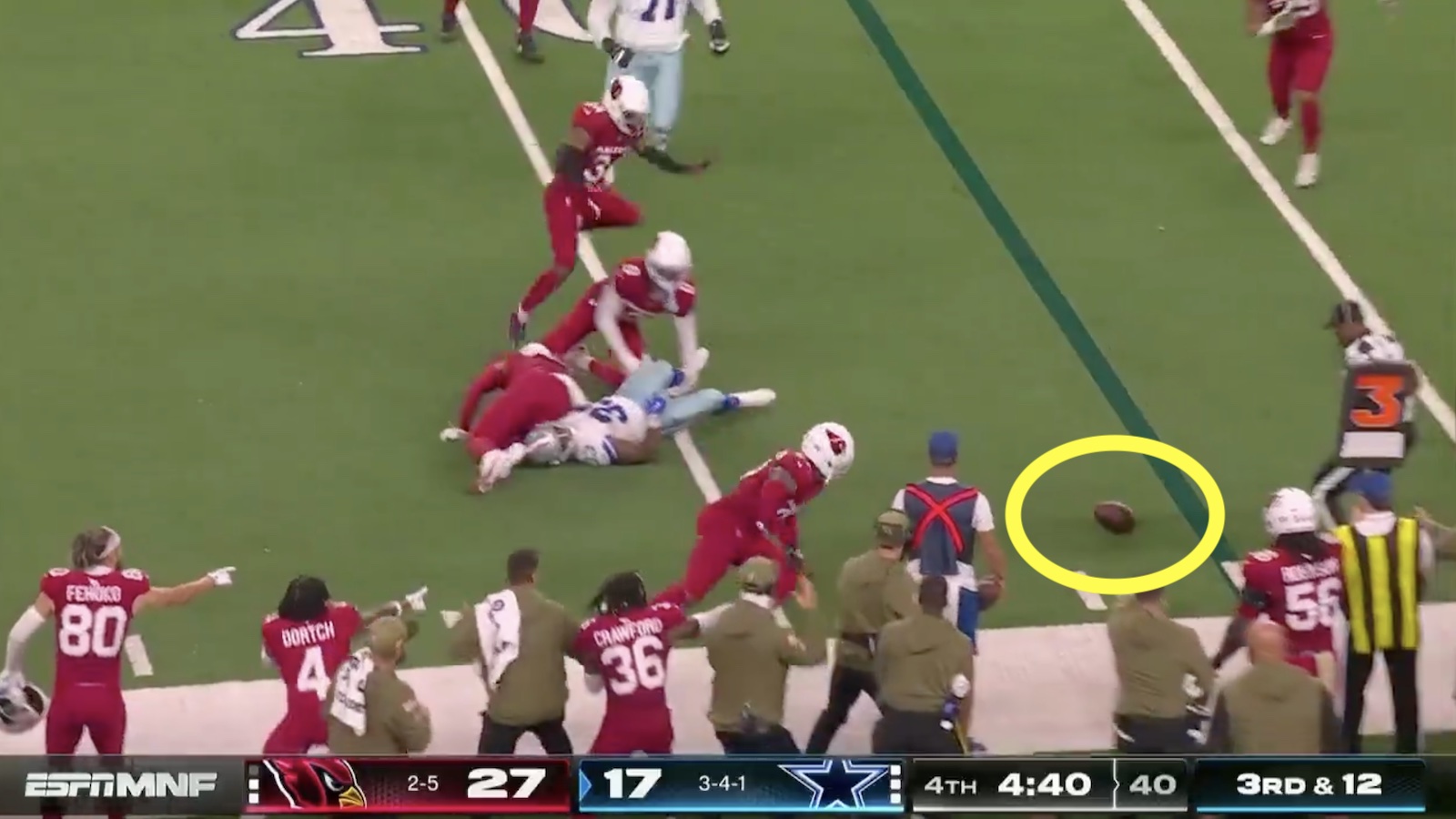 Cowboys' Javonte Williams fumbles the football near the Cardinals' sideline