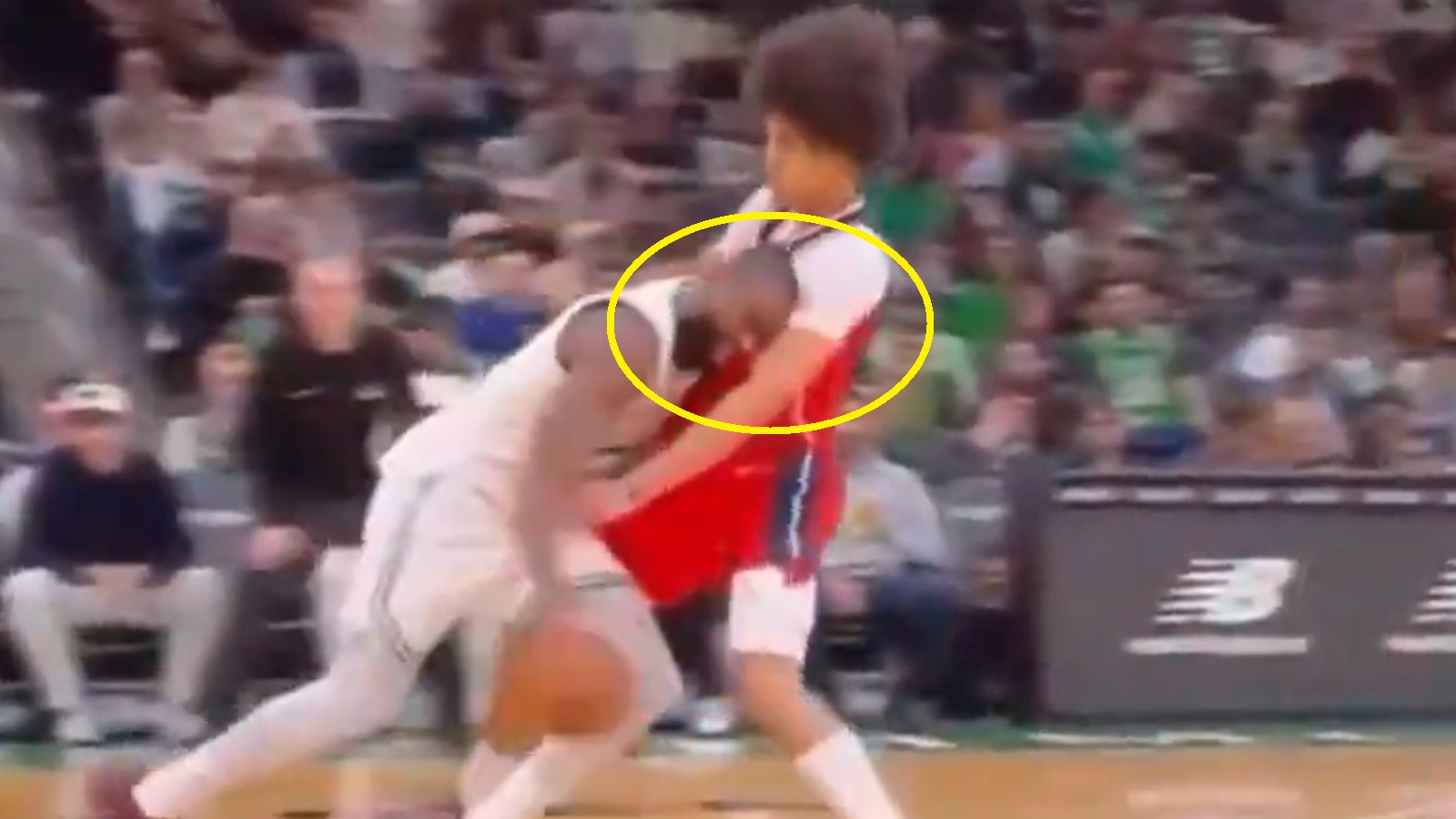 Jaylen Brown colliding with an opponent