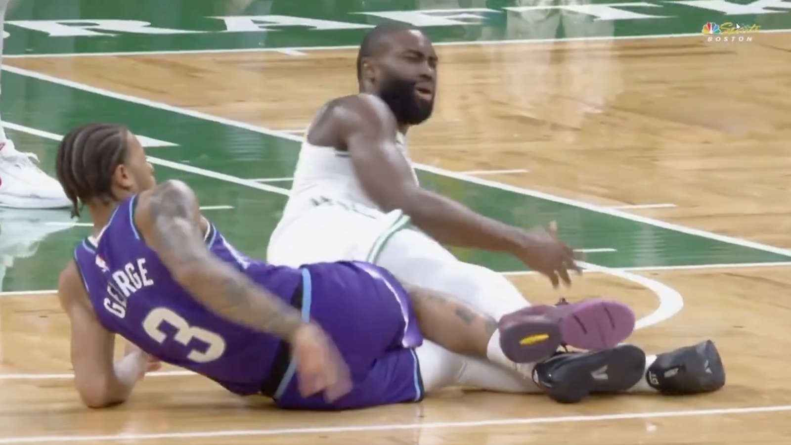 Celtics star Jaylen Brown looking angry after getting tripped by Jazz guard Keyonte George