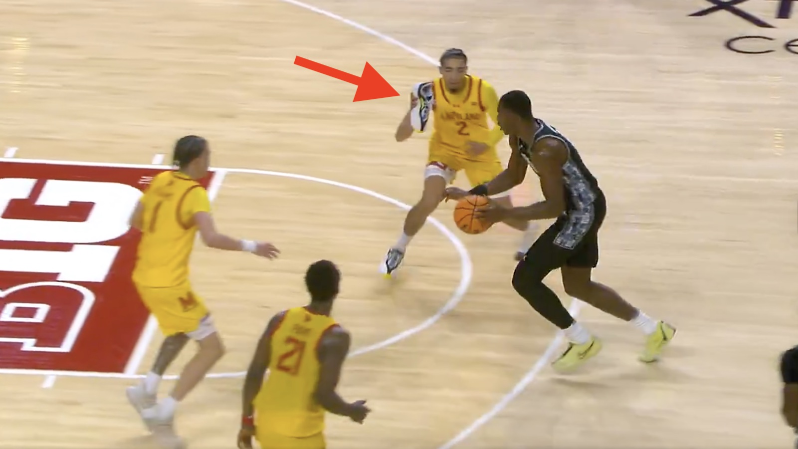 Maryland guard Myles Rice throws his lose shoe at a Georgetown player
