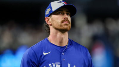 Shane Bieber wearing a Blue Jays hat