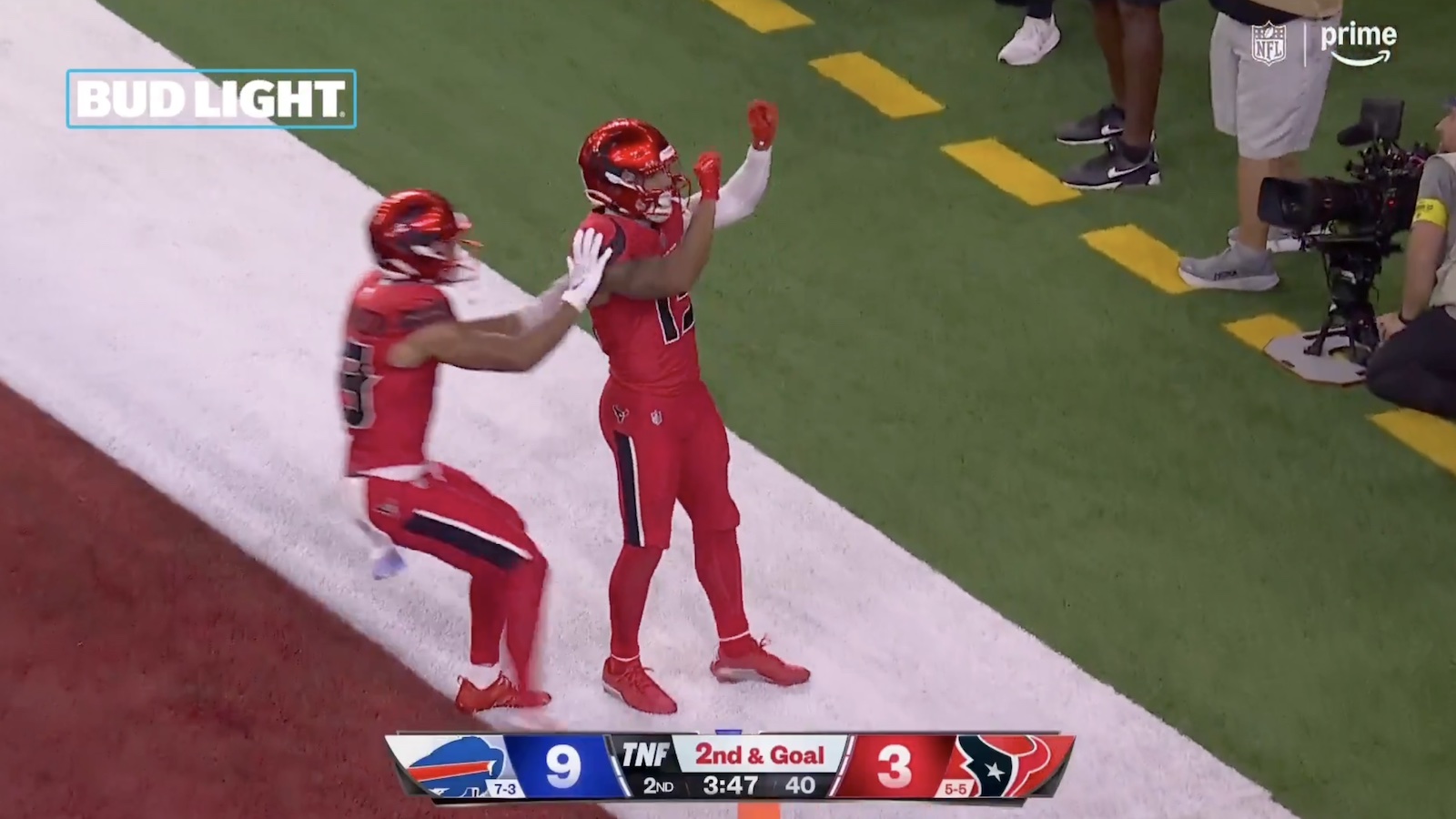 Texans players celebrating in their alternate "Battle Red" uniforms