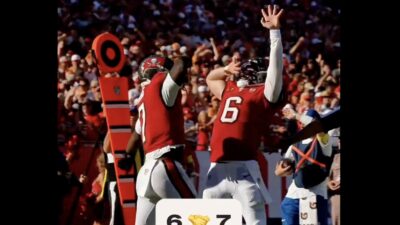 Baker Mayfield and Bucky Irving doing the "nose swipe" celebration