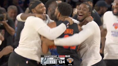 Knicks players mobbing Karl-Anthony Towns after winning 2025 NBA Cup