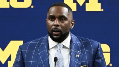 Sherrone Moore at a press conference