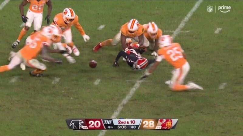 Buccaneers players trying to recover a Falcons fumble