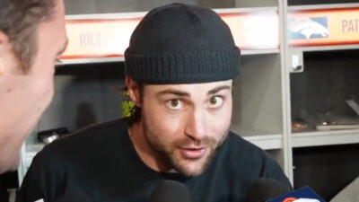 Riley Moss talking to reporters