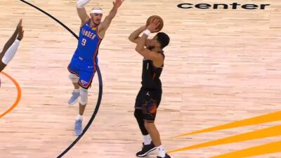 Devin Booker shooting a three-pointer