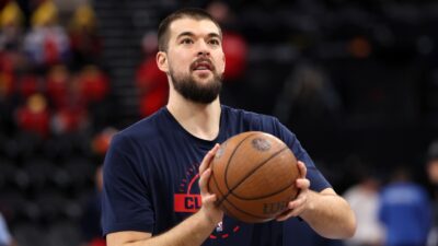 Ivica Zubac holding a basketball