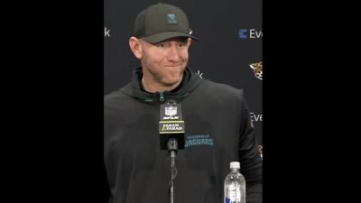 Liam Coen smiling at a Jaguars reporter