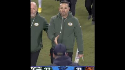 Matt LaFleur and Ben Johnson walking toward each other for a handshake after Bears-Packers Wild Card game