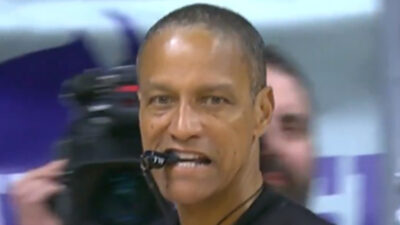 Referee Verne Harris with whistle in mouth