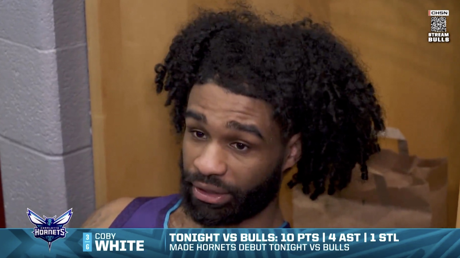 Hornets guard Coby White speaking to reporters after his return to Chicago