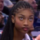 Angel Reese watching an NBA game
