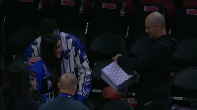 Jalen Suggs helping a young couple during a gender reveal