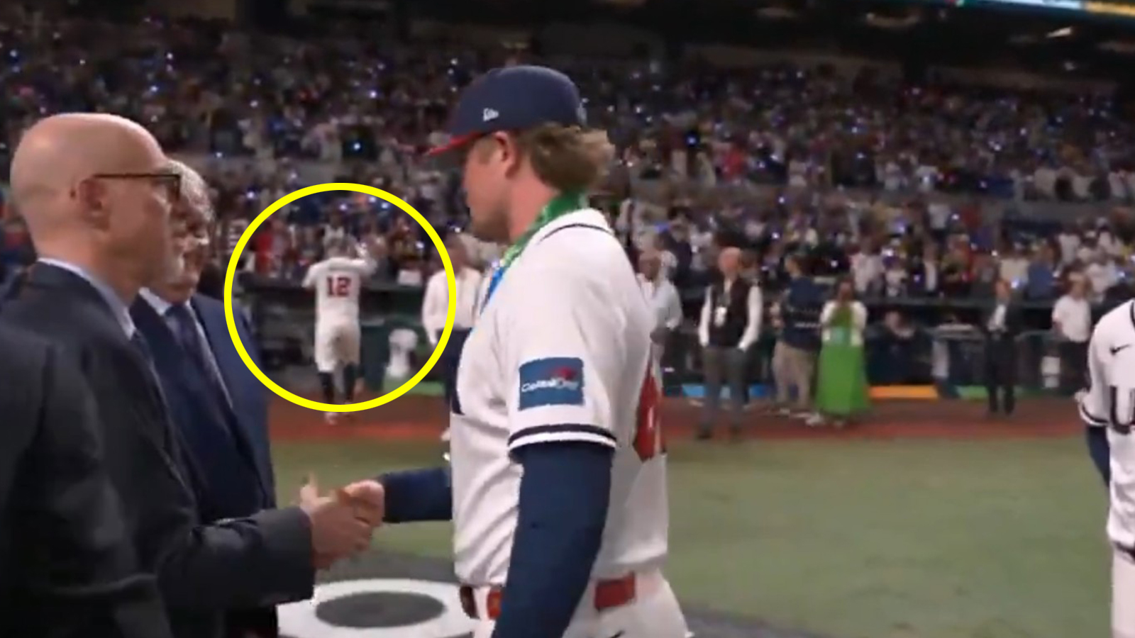 Kyle Schwarber takes off his silver medal