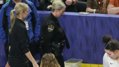 Vanderbilt coach Shea Ralph is escorted to the locker room following an ejection.