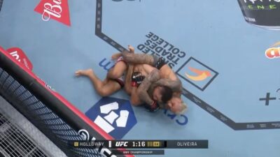 Charles Oliveira choking Max Holloway in the main event of UFC 326