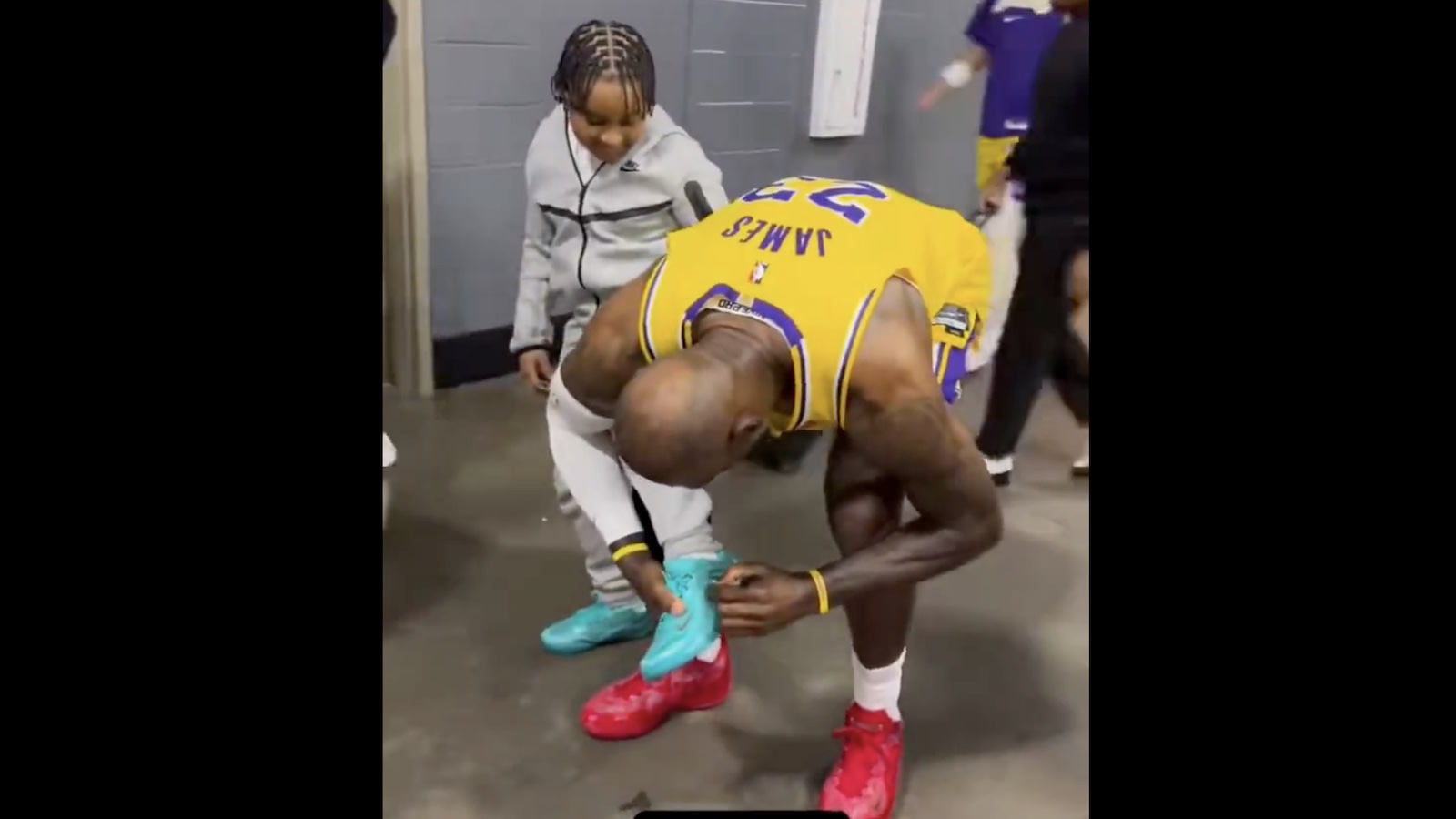 LeBron James signing a kid's shoe after he said "please."