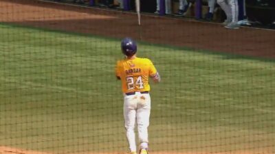 An LSU player flipping their bat
