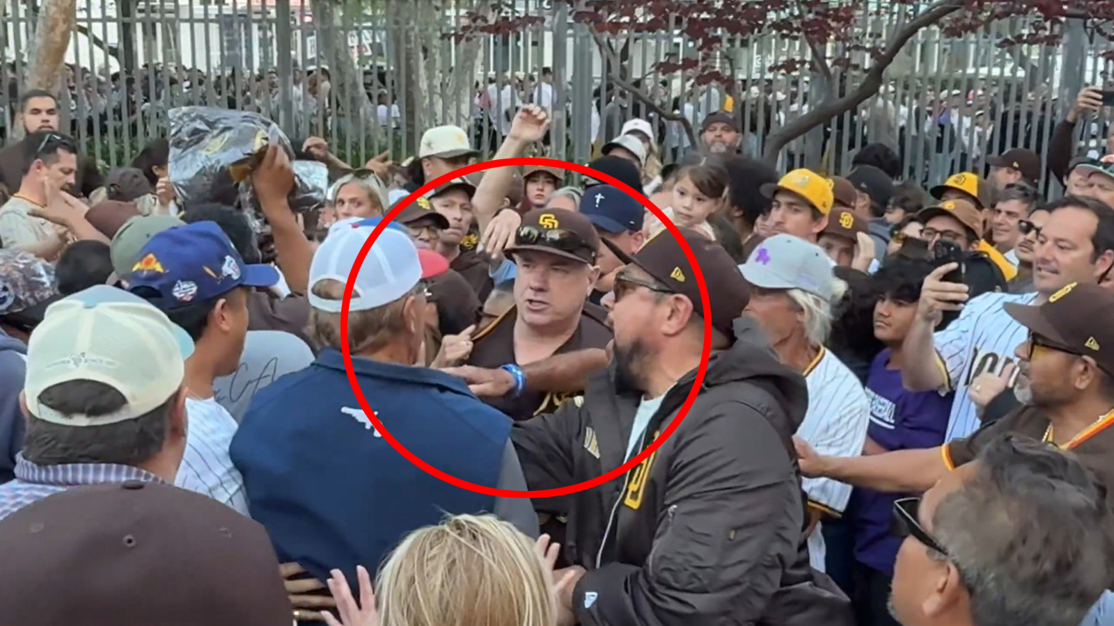San Diego Padres fans squabble during a vest giveaway