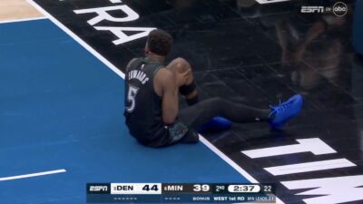 Timberwolves star Anthony Edwards grabbing his knee with an injury in Game 4 against Nuggets