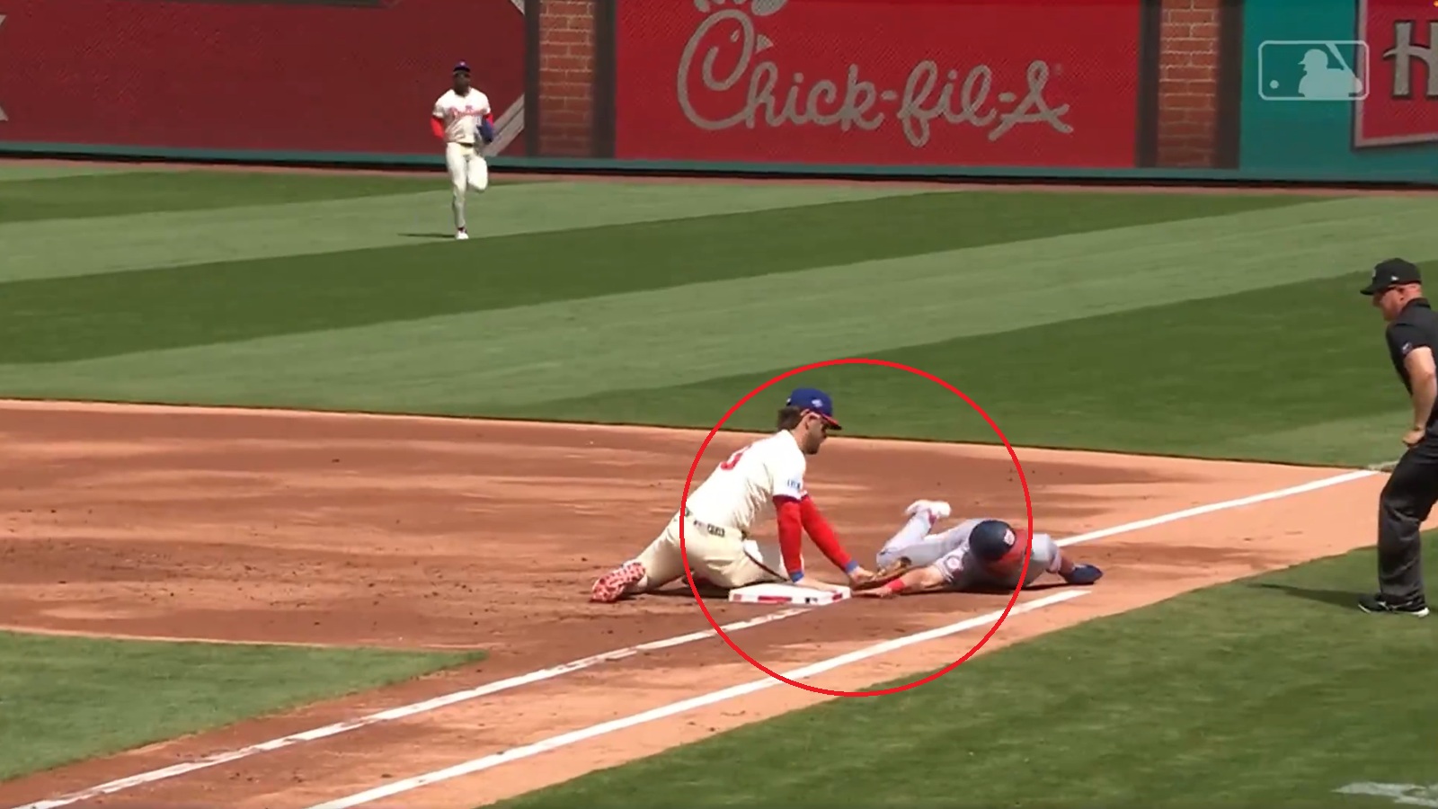 Bryce Harper pushing an arm off a base