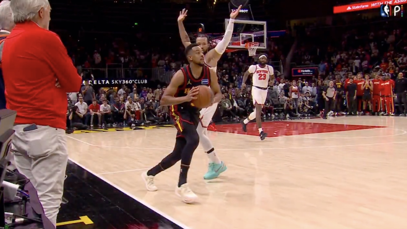 Hawks guard CJ McCollum taking a shot behind the halfcourt line