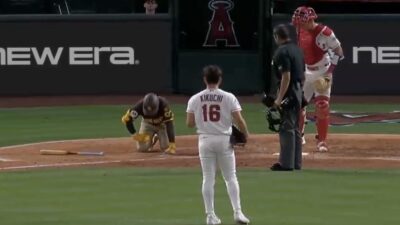 Jake Cronenworth in pain after getting hit by a pitch from Yusei Kikuchi