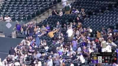 Rockies fan laying out to catch a foul ball