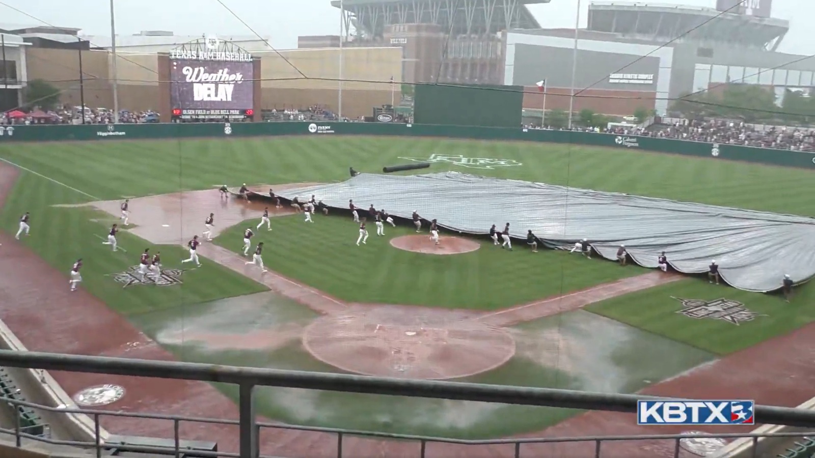 Texas A&M players helping with the tarp