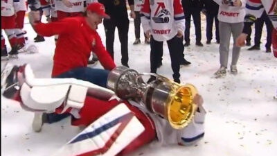 Goalie Alexei Melnichuk falls over with the Gagarin Cup.