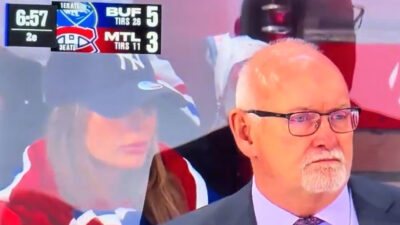 Canadiens fan watching the game from behind the Sabres bench