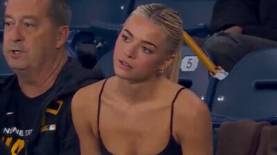Livvy Dunne watching Paul Skenes pitch