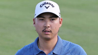 Min Woo Lee walks on the green