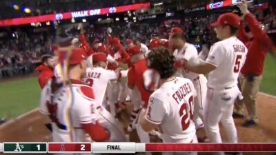 Angels celebrating at the plate after Zach Neto spoiled A's pitcher JT Ginn's no-hitter bid