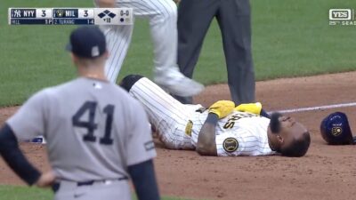 Yankees pitcher Tim Hill looking on after hitting a Brewers runner at third base