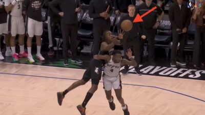 Timberwolves guard Ayo Dosunmu catching a touchdown pass over Spurs guard De'Aaron Fox