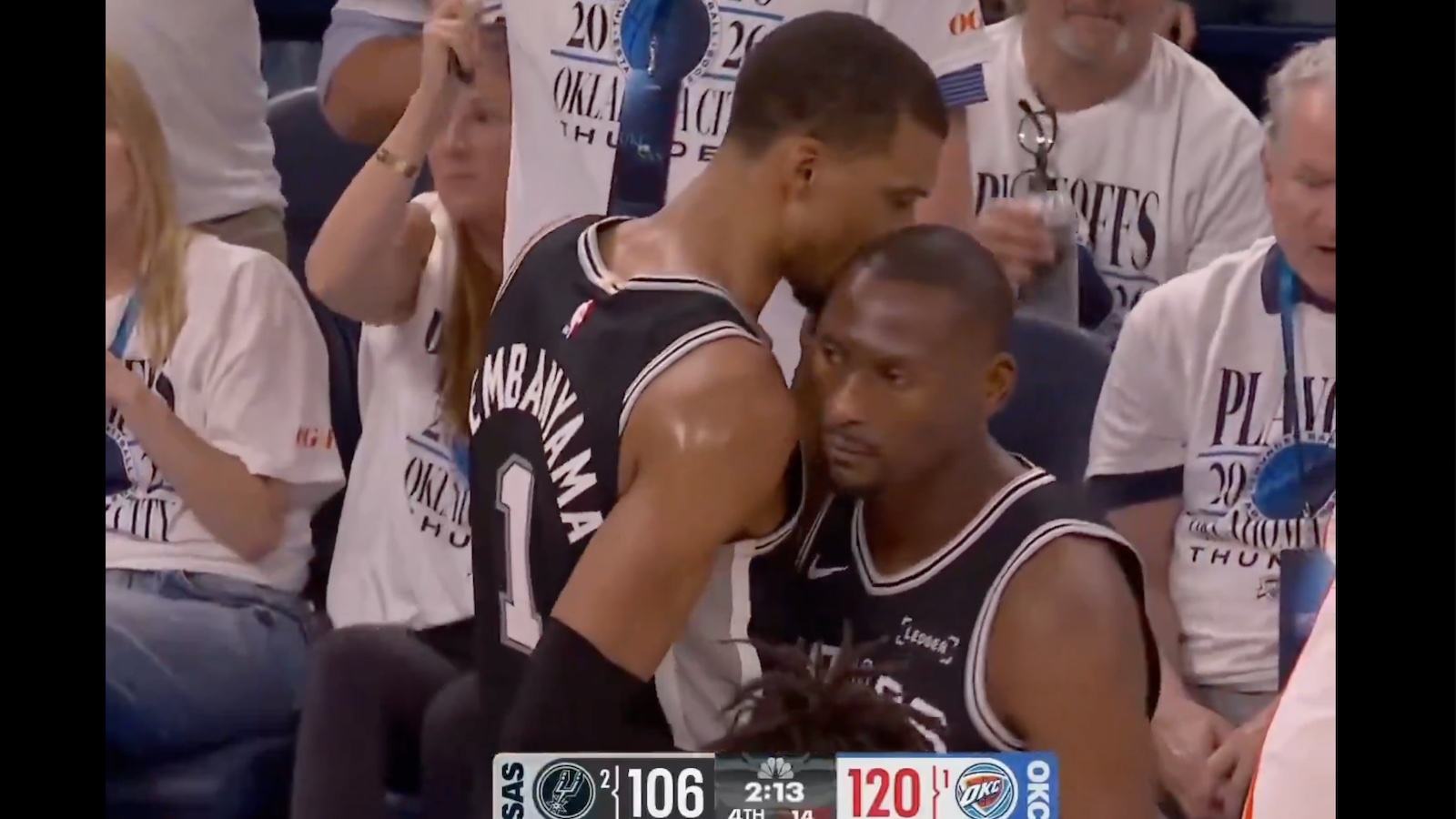 Victor Wembanyama whispering to Bismack Biyombo during Spurs-Thunder Game 5