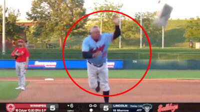 Lincoln Saltdogs manager James Frisbie tosses the first base