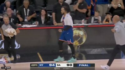 Knicks star Jalen Brunson walking to shake Spurs coach Mitch Johnson's hand after Game 5 of the NBA Finals