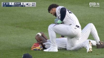 Jazz Chisholm Jr on the ground after getting clotheslined by Yankees teammate Jasson Dominguez