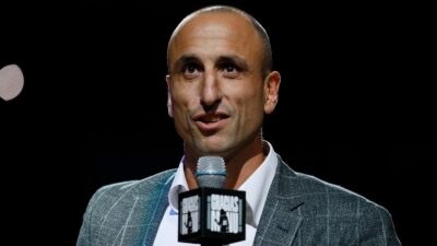 Manu Ginobili holding a microphone