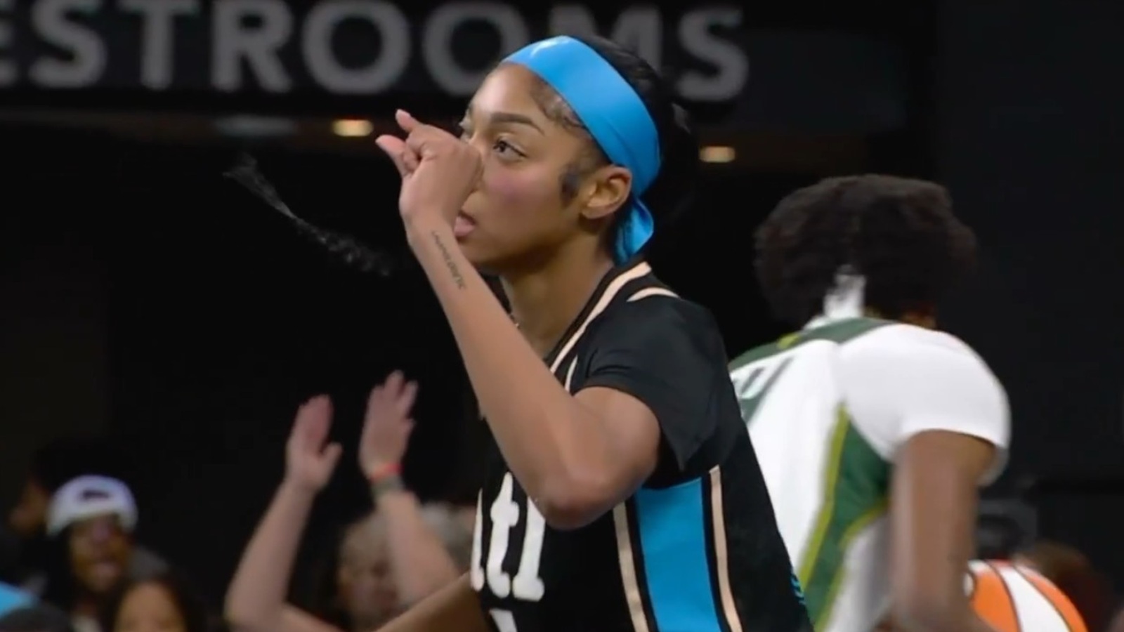 Angel Reese doing the 'too small' gesture